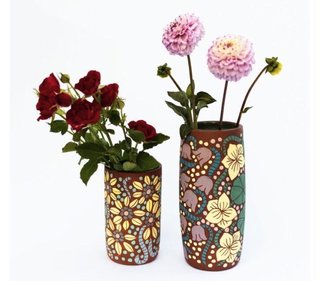 These tall, cylindrical vases thrown on the wheel using Navaho clay. I then hand painted floral motifs and carved details before drying and firing. I then glazed the inside a vibrant turquoise for a nice contrast to hold large blooms.